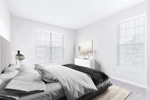 A bedroom with a large bed and a painting on the wall at Elan at Mallard Creek Apartment Homes, North Carolina, 28269