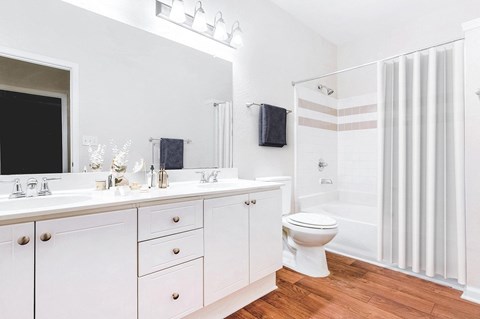 A white bathroom with a toilet, sink, and shower at Elan at Mallard Creek Apartment Homes, Charlotte, 28269