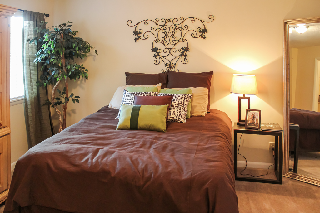 furnished bedroom with carpeted flooring and window