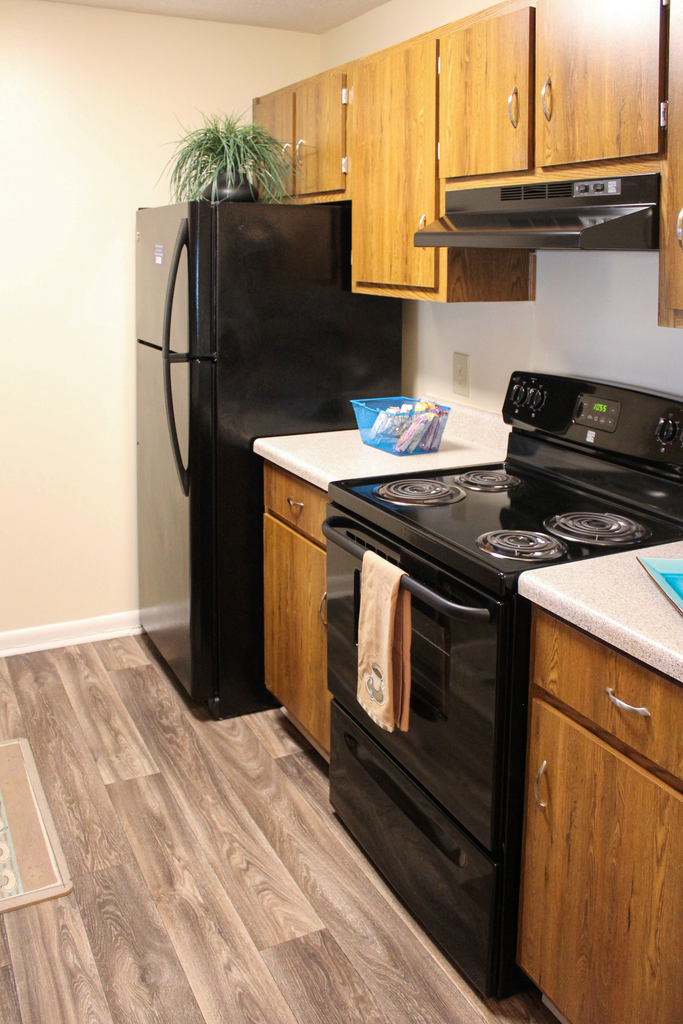 kitchen with wood cabinetry and black appliances