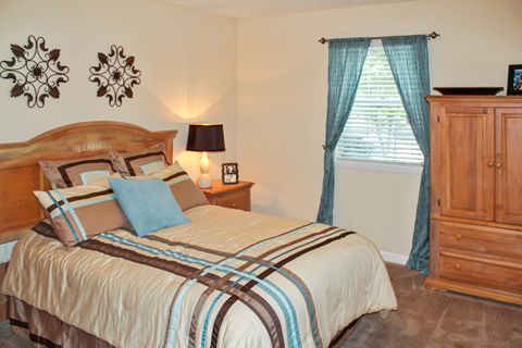 furnished bedroom with carpeted flooring and window