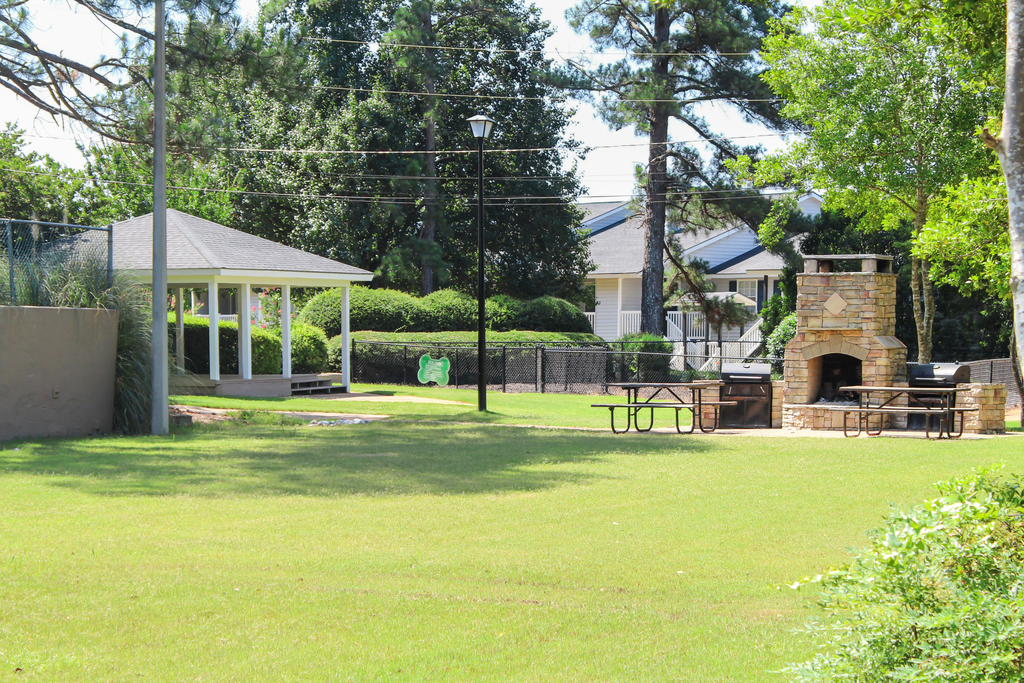 green space with outdoor fireplace and grills