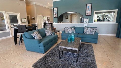 A living room with a blue couch and a coffee table.