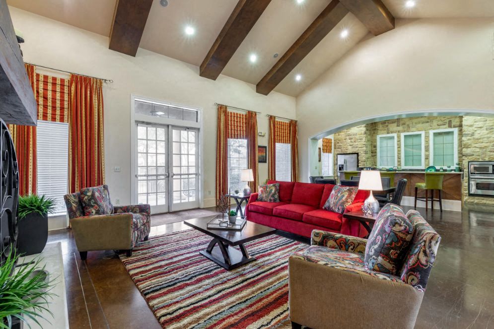 A living room with a red couch and a coffee table.