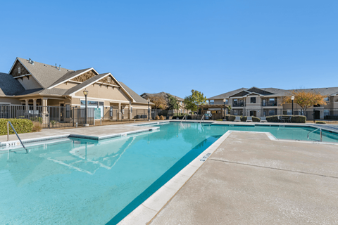 A large swimming pool in front of a building.