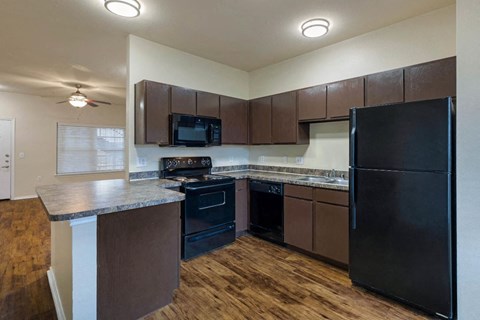 a kitchen with black appliances and a counter top