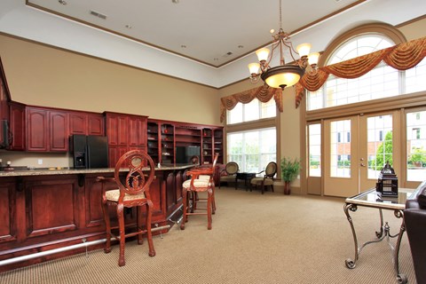 A kitchen with red cabinets and a dining table with chairs.
