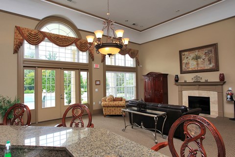 A living room with a piano and a fireplace.