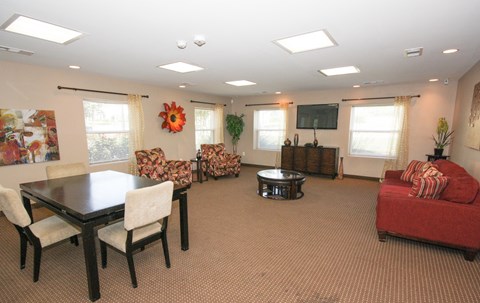 A living room with a dining table and chairs.