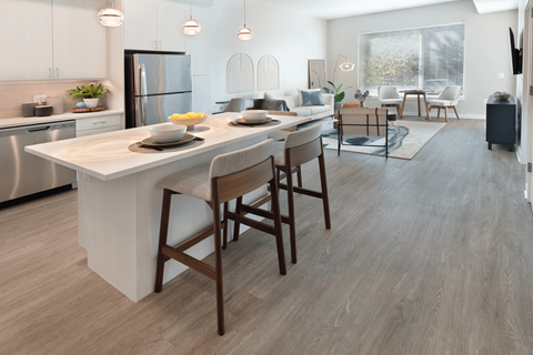 A modern kitchen with a dining table and chairs.