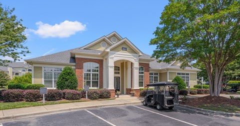 A house with a golf cart parked in front.