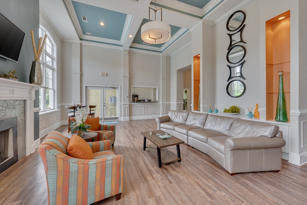 A living room with a fireplace and a striped chair.