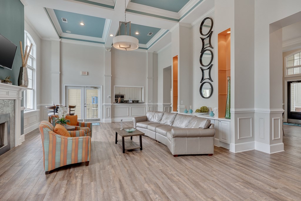 Clubhouse living room with a fireplace and a striped chair.