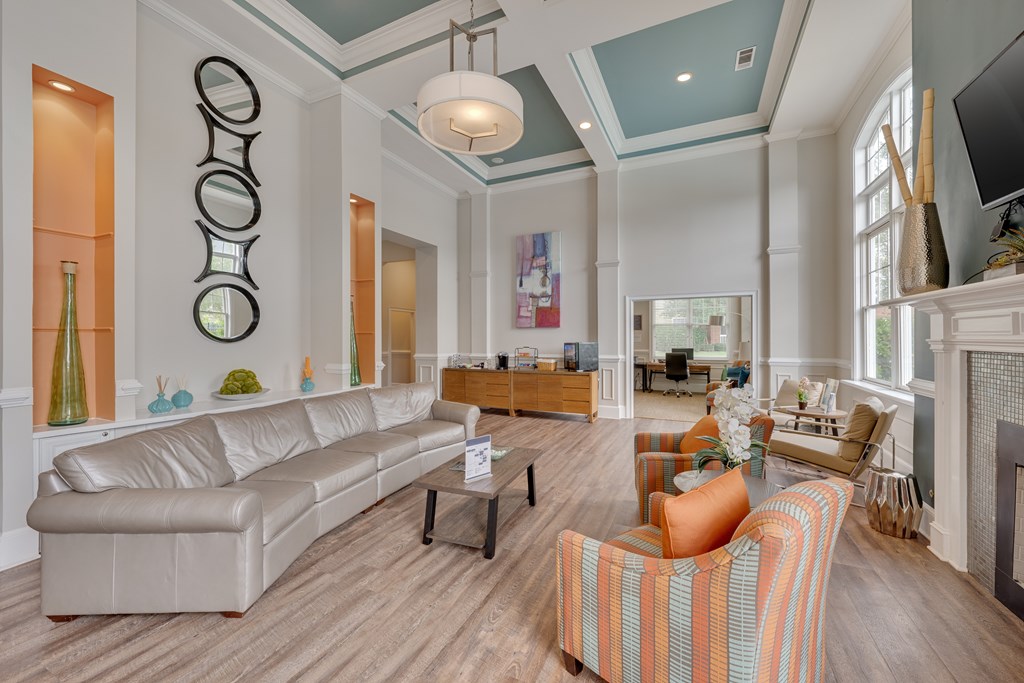 Clubhouse rest area with a white couch and a fireplace.