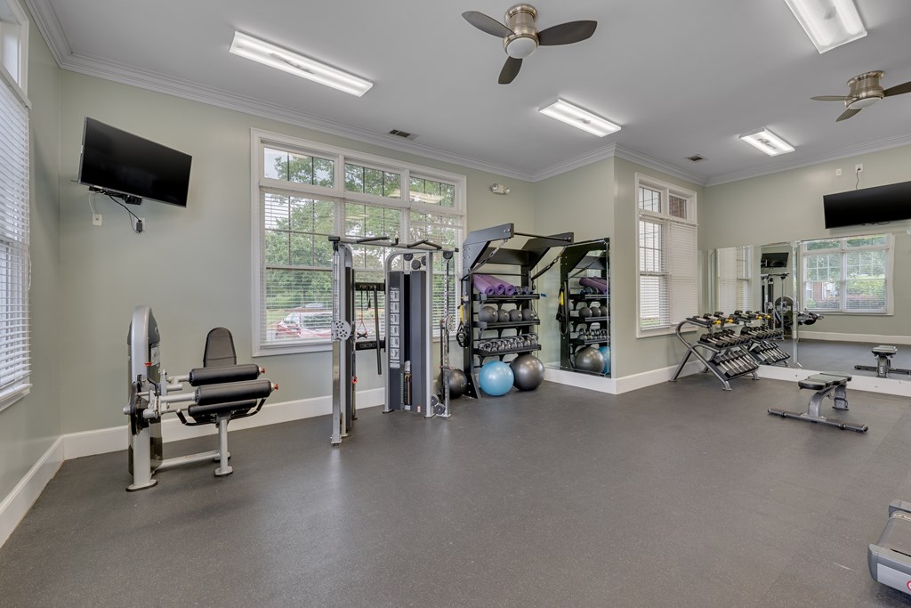 A spacious home gym with a variety of exercise equipment.