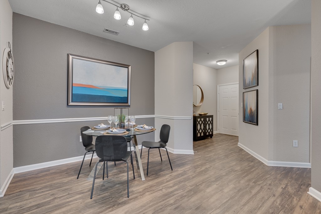 A dining room with a table set for four.