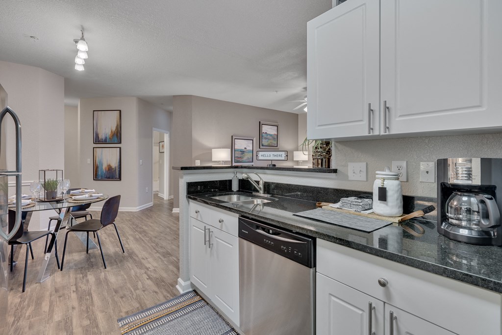 A kitchen with a dining table and chairs.