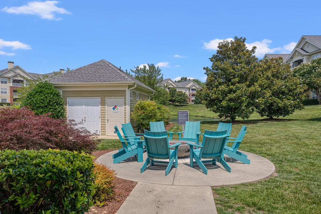 A set of six green chairs are arranged around a table in a circle.