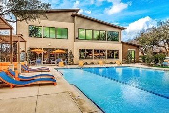 Swimming Pool with tanning deck and building exterior in background