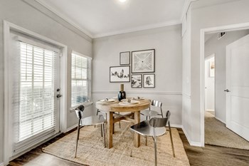 dining room table with chairs with large windows and door to outside