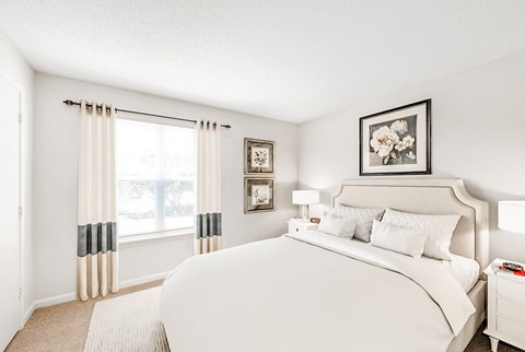 a bedroom with a large bed and a large window