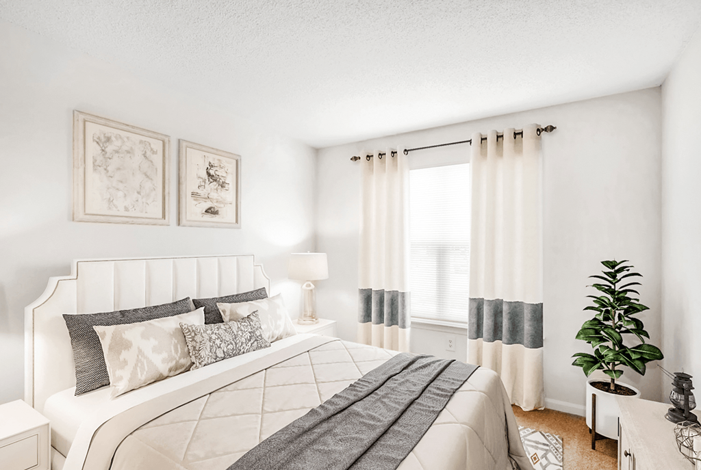 a bedroom with a large bed and a large window