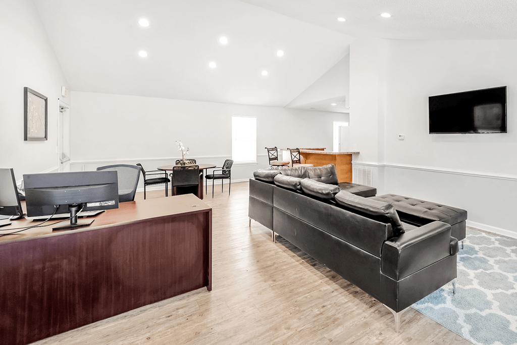 a living room with white walls and hardwood floors