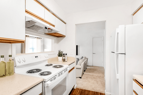 a kitchen with white appliances and a white refrigerator
