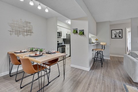 A dining room with a table set for four.