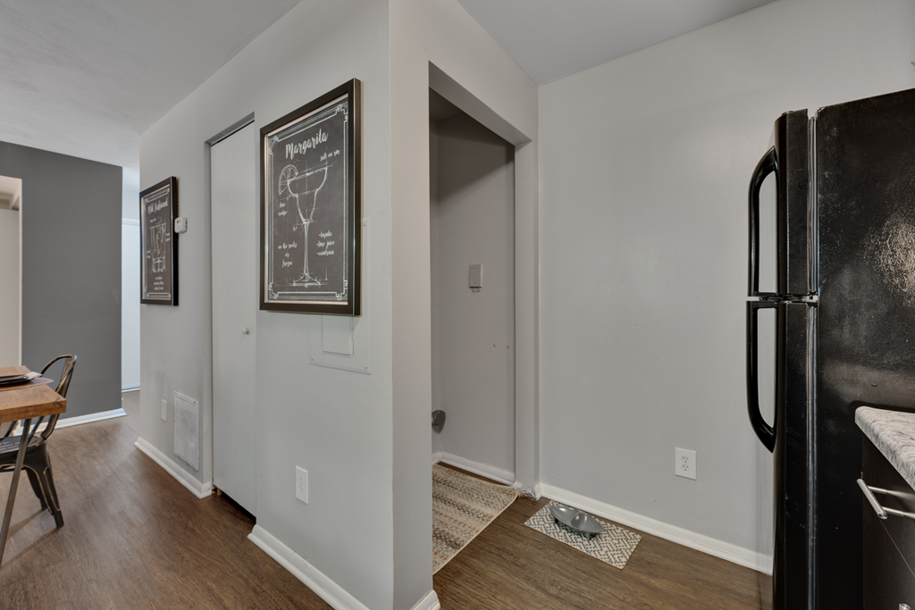 kitchen with hardwood-style flooring and black refrigerator