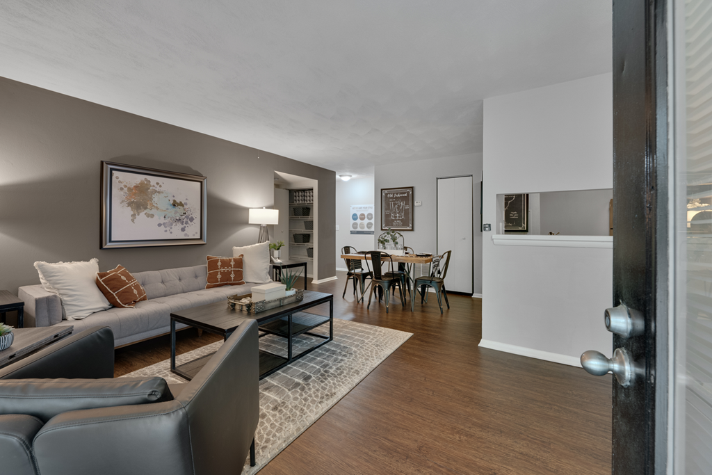 A living room with a grey couch and a coffee table.