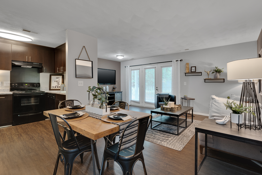 A kitchen and dining room with hardwood-style flooring
