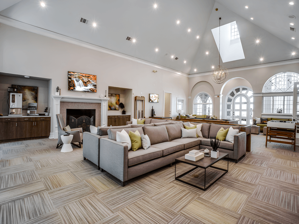 a large living room with couches and a fireplace