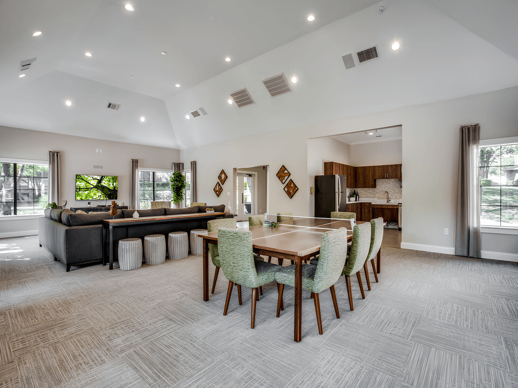 a large living room and dining room with a table and chairs