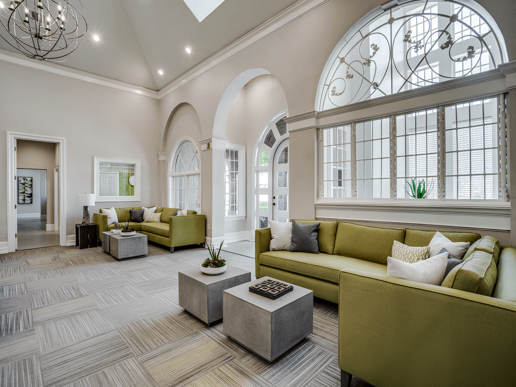 a living room with large windows and couches