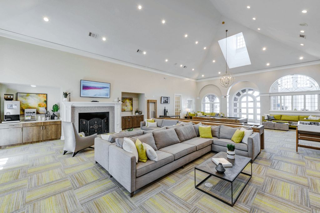 a large living room with couches and a fireplace