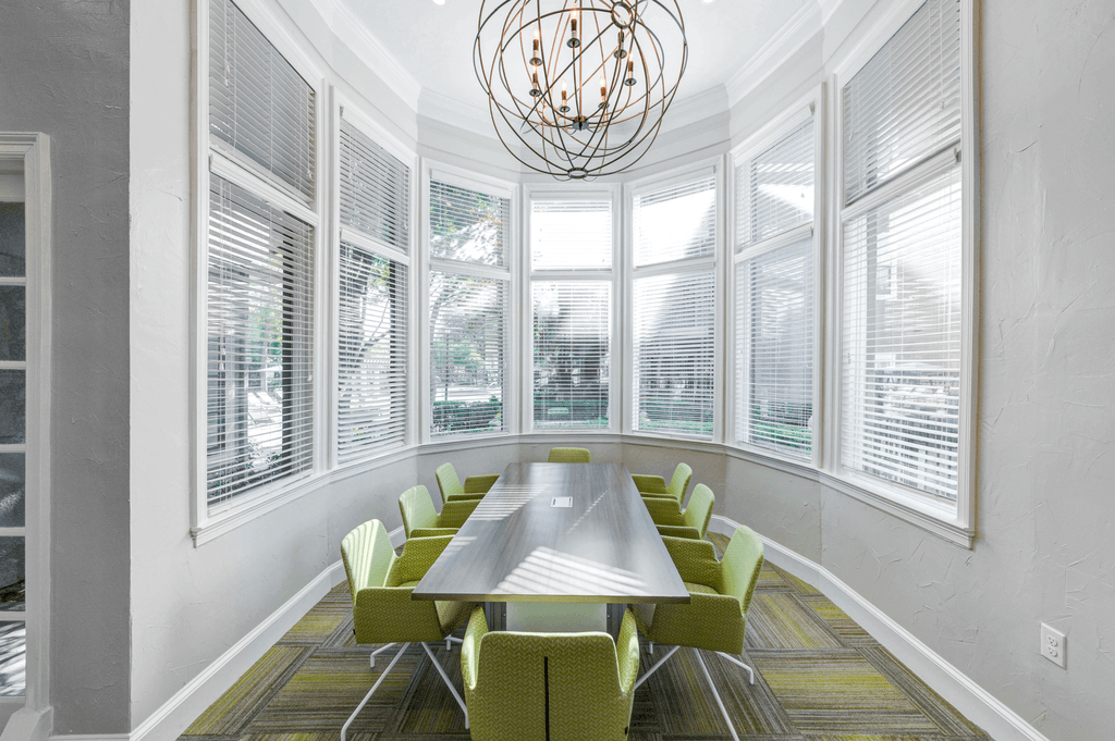 a conference room with large windows and a table and chairs