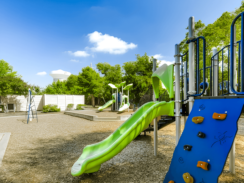 a playground with a slide and other toys in a park