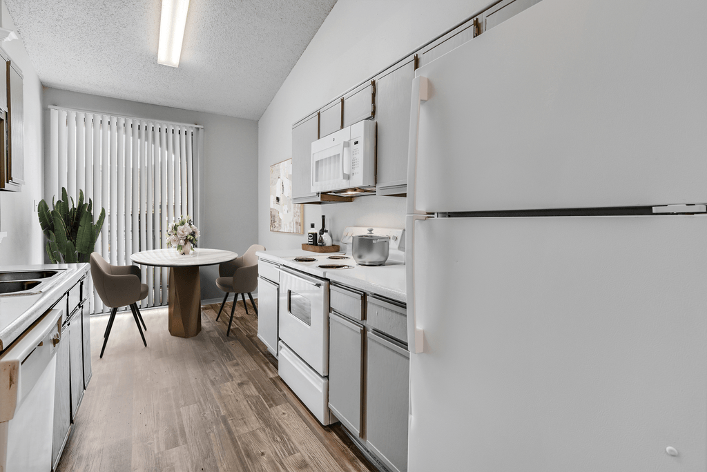 our apartments offer a modern kitchen and dining room with white appliances