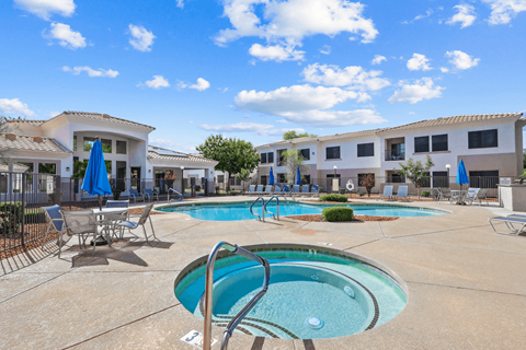 Pool area with spa and lounge seating at Lake Pleasant Village Apartments, Arizona
