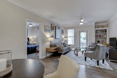 A living room with a grey couch and a wooden table.
