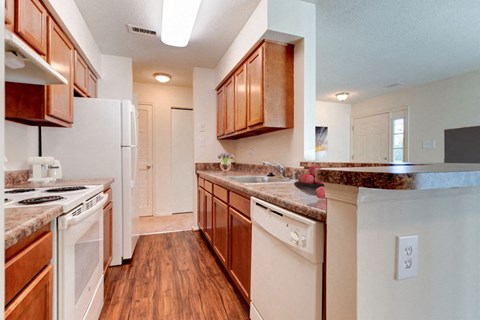 A kitchen with wooden cabinets and white appliances.
