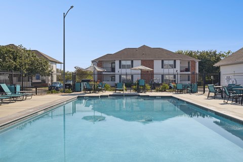 A swimming pool in front of a residential building.