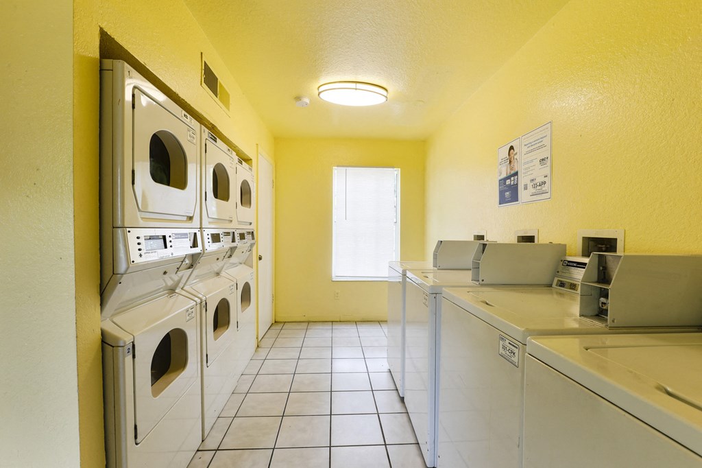 Laundry center with washer and dryers and tile flooring