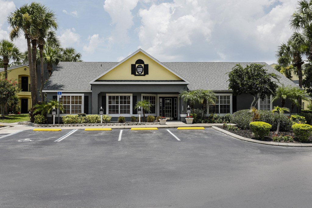 Club House Entrance with long sidewalk surrounded by trees