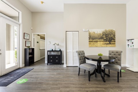 A dining room with a table and chairs.