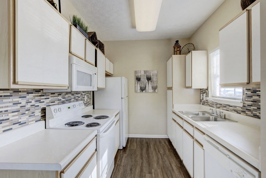 a kitchen with white appliances and white cabinets