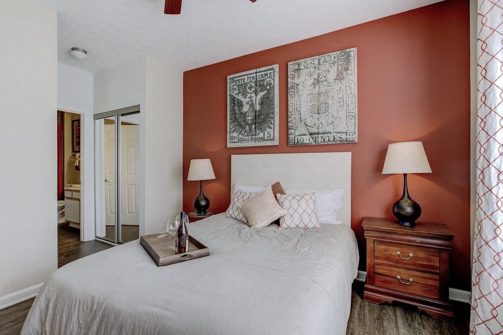 a bedroom with a white bed and two lamps