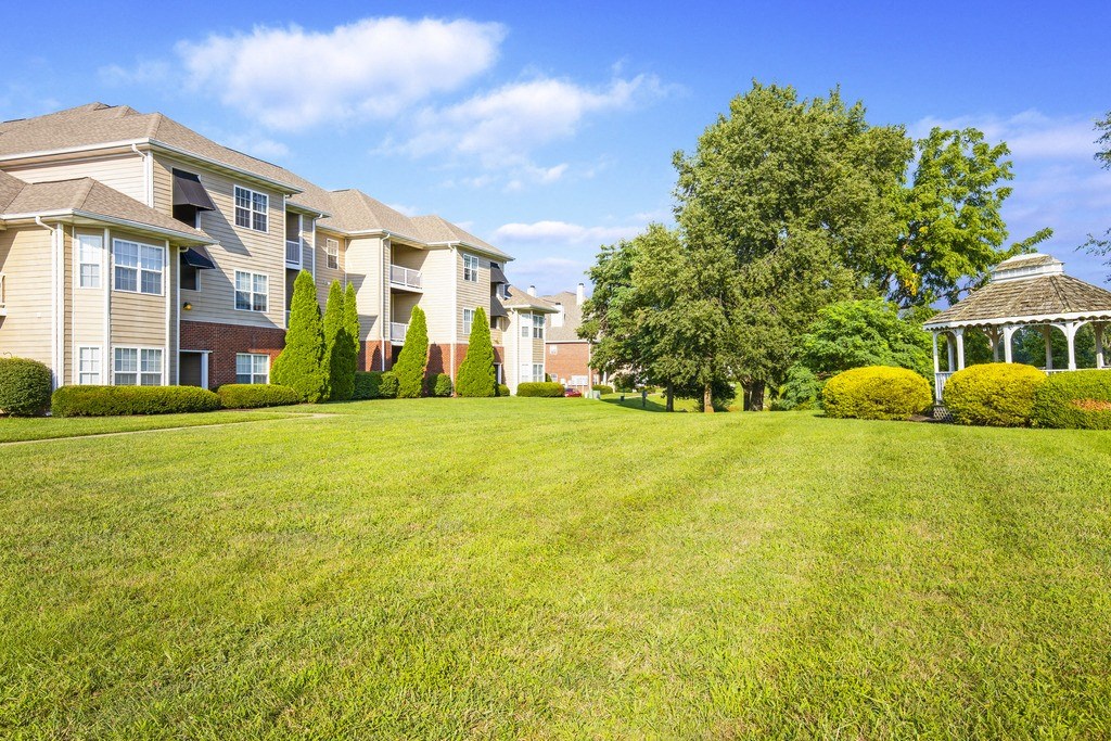 a large lawn in front of some apartment buildings