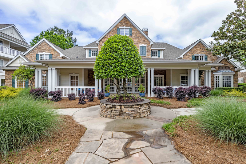 a large house with a courtyard with a fountain in front of it